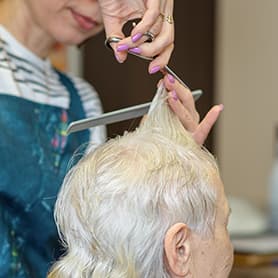 A resident having a haircut