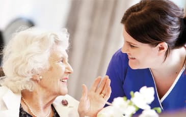 A smiling resident and carer