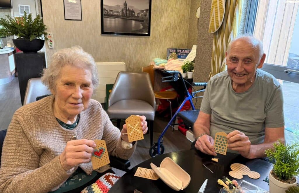 residents doing cross stitch