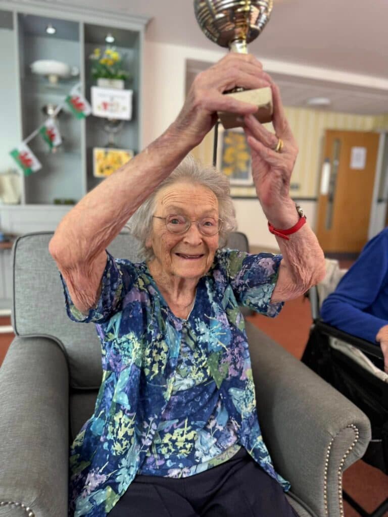 one of our residents holding up a trophy